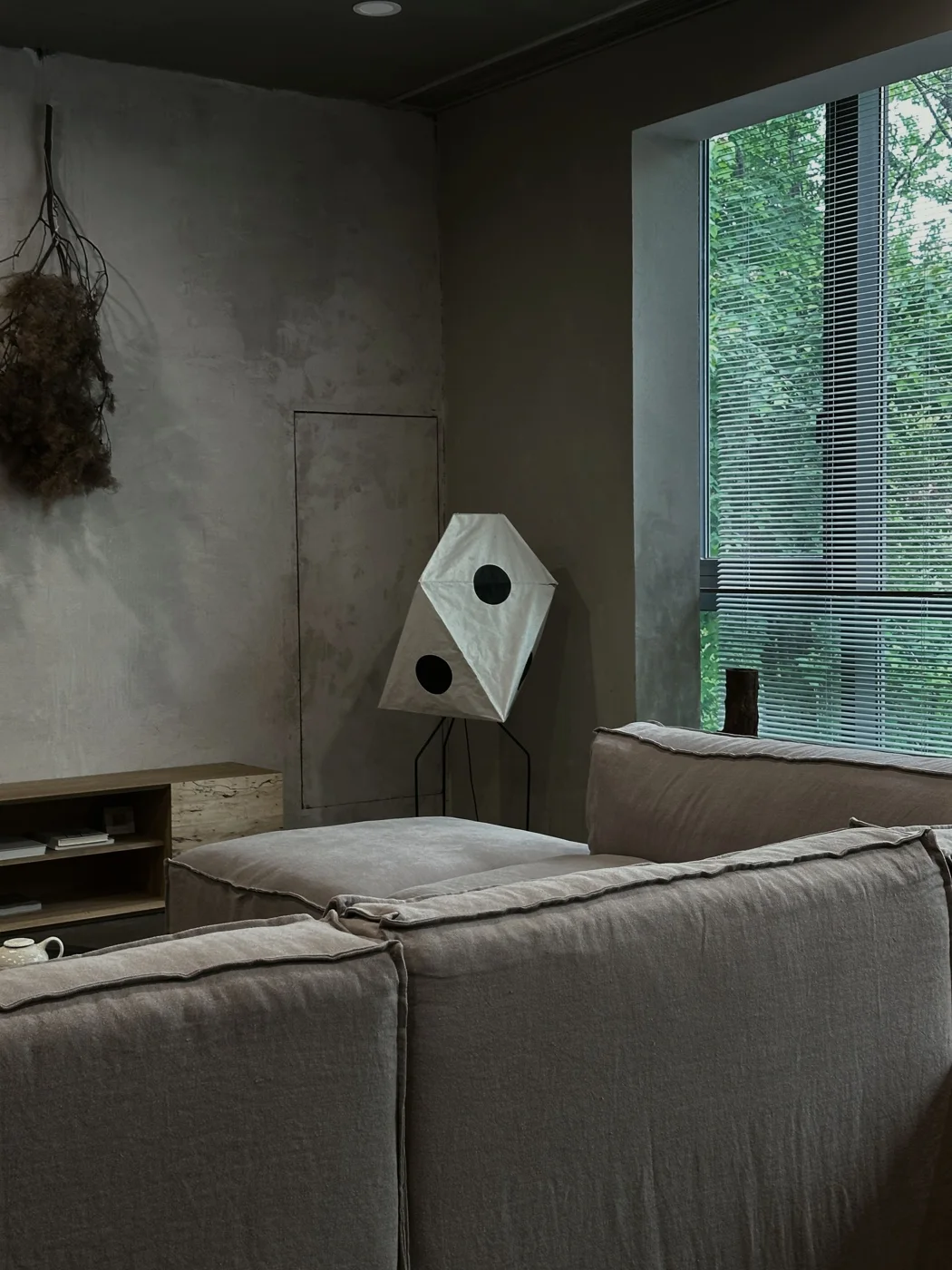 Quiet contemporary living space with natural materials and garden-facing windows