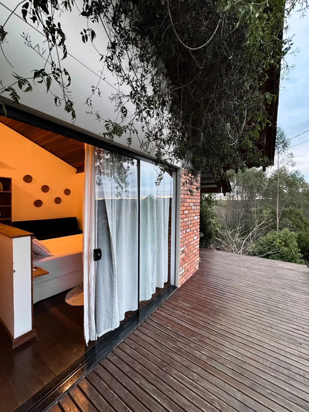 Brick-built home with glazing opening onto a timber terrace
